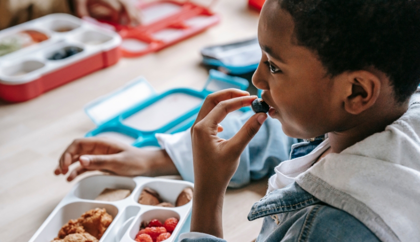 Criança se alimentando na escola